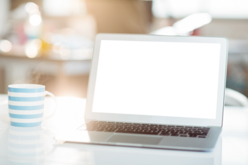 Laptop and coffee mug on table