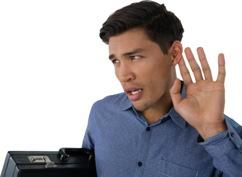 Young businessman cupping ears