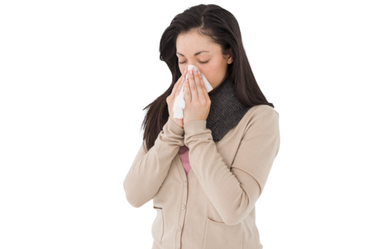 Sick brunette blowing her nose