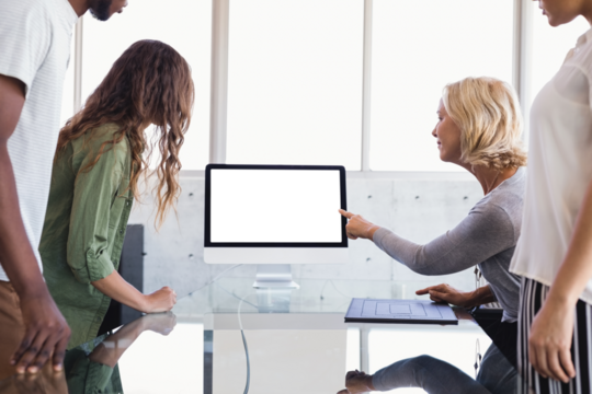 Colleagues looking at computer monitor during discussion