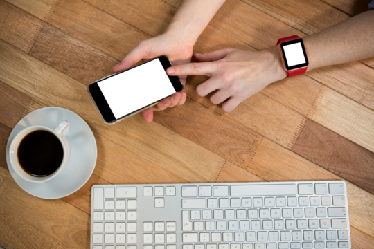 Overhead view of businesswoman with smart watch using mobile phone - Powered by Adobe
