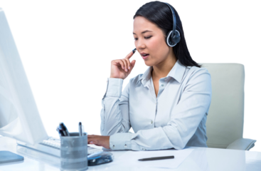 Concentrated businesswoman with headset using computer