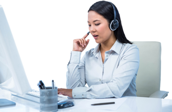Concentrated businesswoman with headset using computer