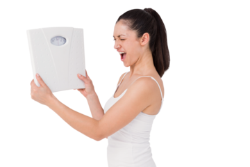 Fit woman holding weighing scales