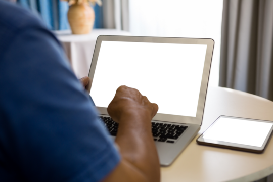Cropped hand of senior man using laptop in nursing home - Powered by Adobe