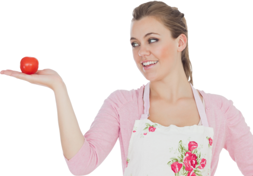 Woman looking at tomato - Powered by Adobe
