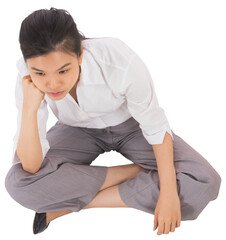 Businesswoman sitting cross legged leaning on hand