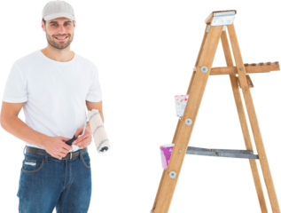 Man holding paint roller while standing by ladder