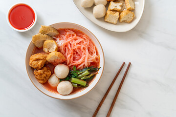 small flat rice noodles with fish balls and shrimp balls in pink soup, Yen Ta Four or Yen Ta Fo