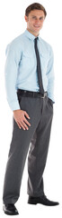 Obraz premium Smiling businessman standing with hand in pocket