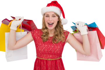 Excited blonde in santa hat holding shopping bags