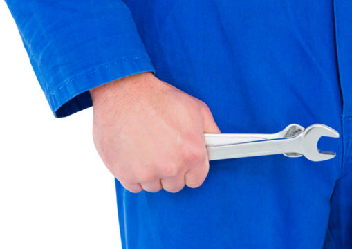 Mechanic holding spanners on white background