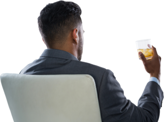 Rear view of businessman holding whisky glass