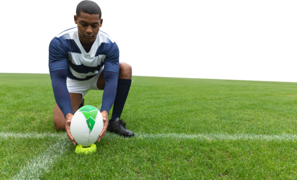 Male rugby player placing the ball