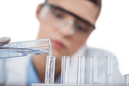 Female scientist pouring chemical