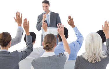 Business people raising their arms during meeting 
