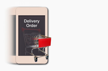 Delivery  and online shopping concept, an empty shopping cart and it  flows from smartphone .