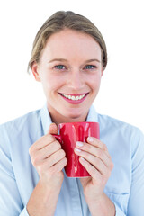 Businesswoman holding her mug and smiling 