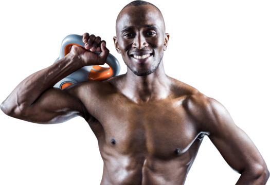 Portrait of muscular man smiling while holding kettlebell