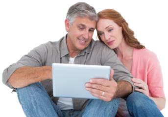 Casual couple sitting using tablet