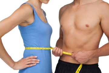 Mid section of a fit man measuring womans waist