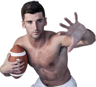 Shirtless rugby player defending