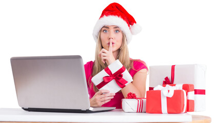 Festive blonde shopping online with laptop