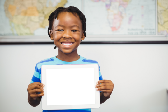 Boy holding digital tablet at classroom