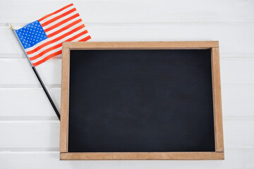Chalkboard and American flag on table