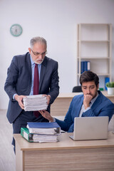 Two male colleagues working in the office