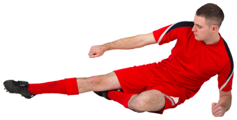 Fit football player playing and kicking