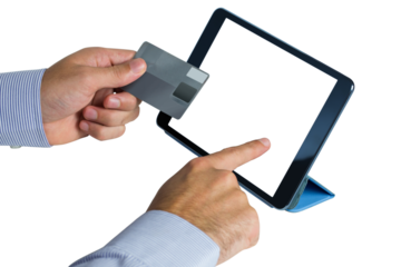 Businessman using digital tablet while holding credit card