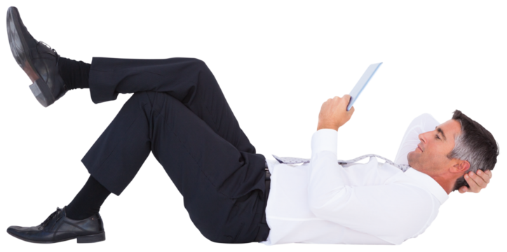 Businessman using tablet computer while lying on white background - Powered by Adobe