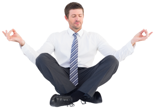 Businessman meditating in lotus pose