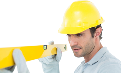 Carpenter wearing hard hat while using spirit level