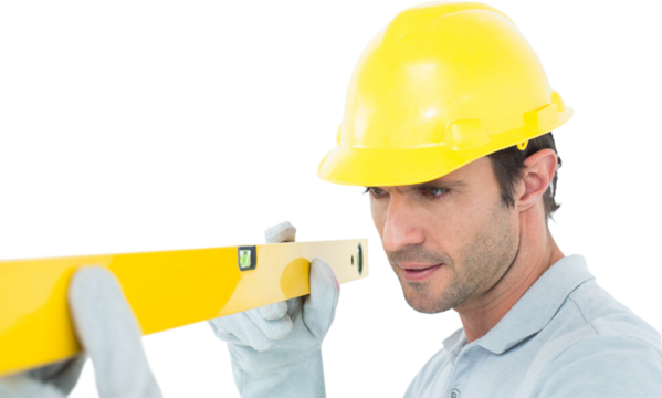 Carpenter wearing hard hat while using spirit level