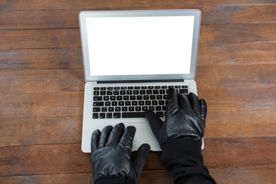 Hacker using laptop at desk