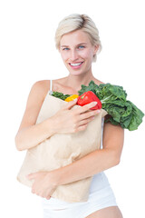 Attractive woman holding bag of vegetables 