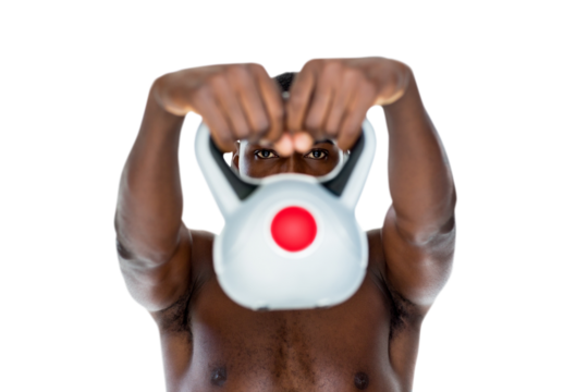 Shirtless fit young man lifting kettle bell