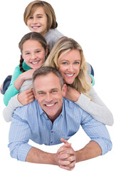 Cheerful family lying over white background