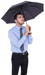 Anxious businessman sheltering with umbrella 