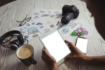 Businesswoman using digital tablet at creative office desk