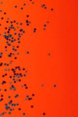 Red, blue and white stars of flag of united states of america with copy space on orange background