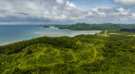 Aerial drone of coastline of Borneo island with beach and rainforest. Sabah, Malaysia.
