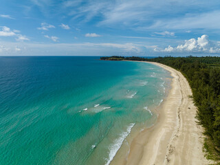 Fototapeta na wymiar Beautiful sandy beach with trees and sea surf with waves. Kalampunian Beach. Borneo, Malaysia.