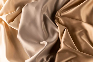 Photo sur Plexiglas Poussière Close up of plain beige satin fabric with folds, copy space