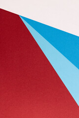 Close up of white and blue paper on red background with copy space