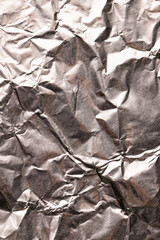 Close up of crumpled and shiny gold foil with copy space