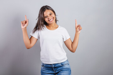 beautiful brazilian woman. denim and white. smiling, dancing. optimistic, very happy.