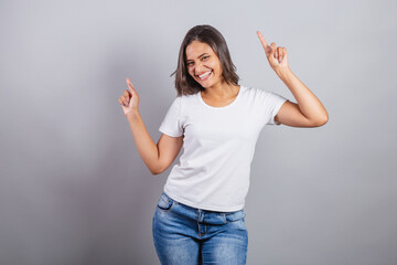 beautiful brazilian woman. denim and white. smiling, dancing. optimistic, very happy.